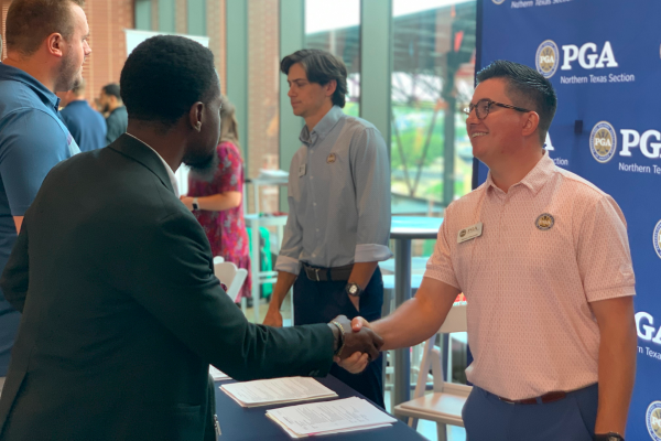 Candidate shaking hands with a PGA Northern Texas Section recruiter at a career fair
