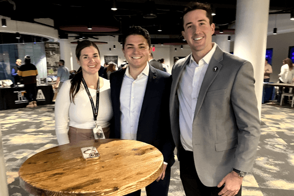 Three attendees posing together at a Cleveland Cavaliers networking event