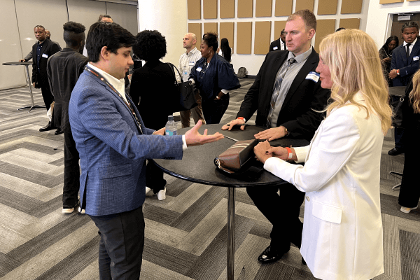 Attendees networking at a table during an Atlanta Hawks career event